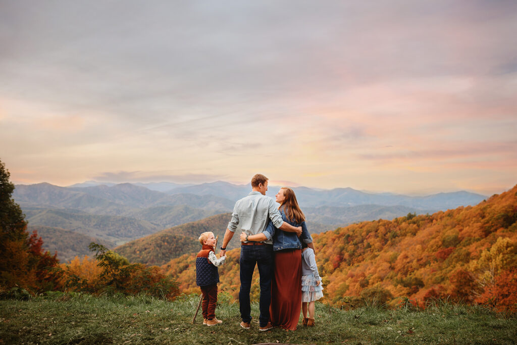 Family takes in thew view from a mountain top during Fall Family Photos on the Blue Ridge Parkway in Asheville, NC.