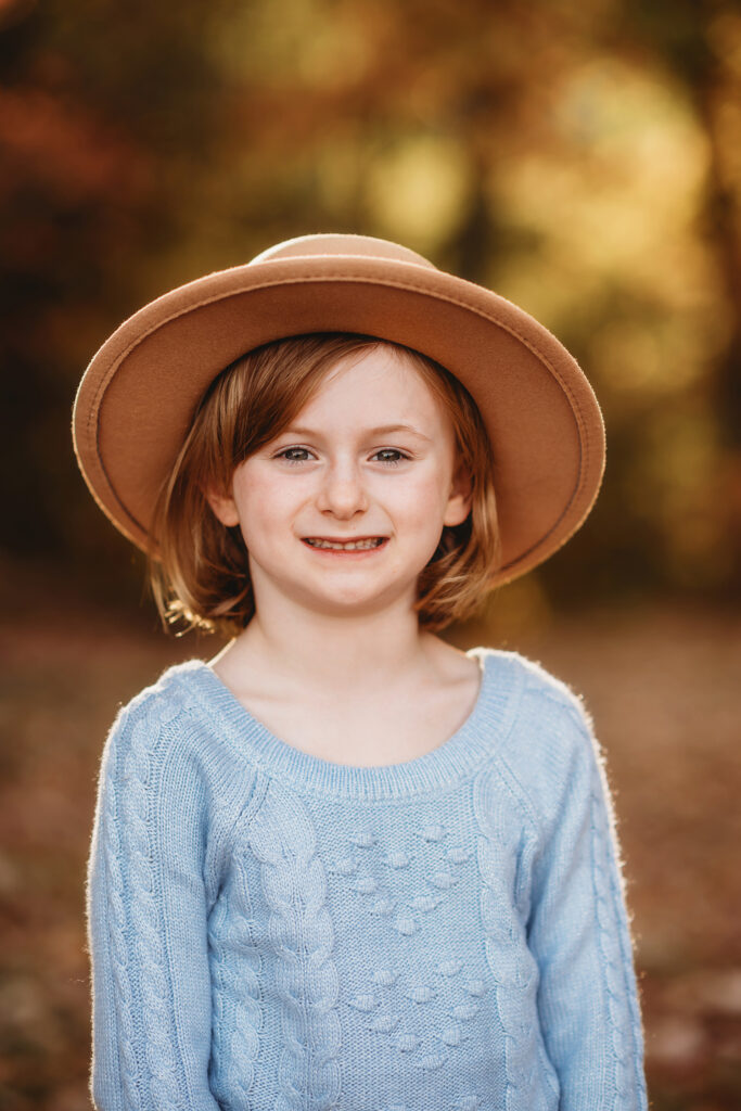 Little girl smiles at the camera during Fall Family Photos on the Blue Ridge Parkway in Asheville, NC.