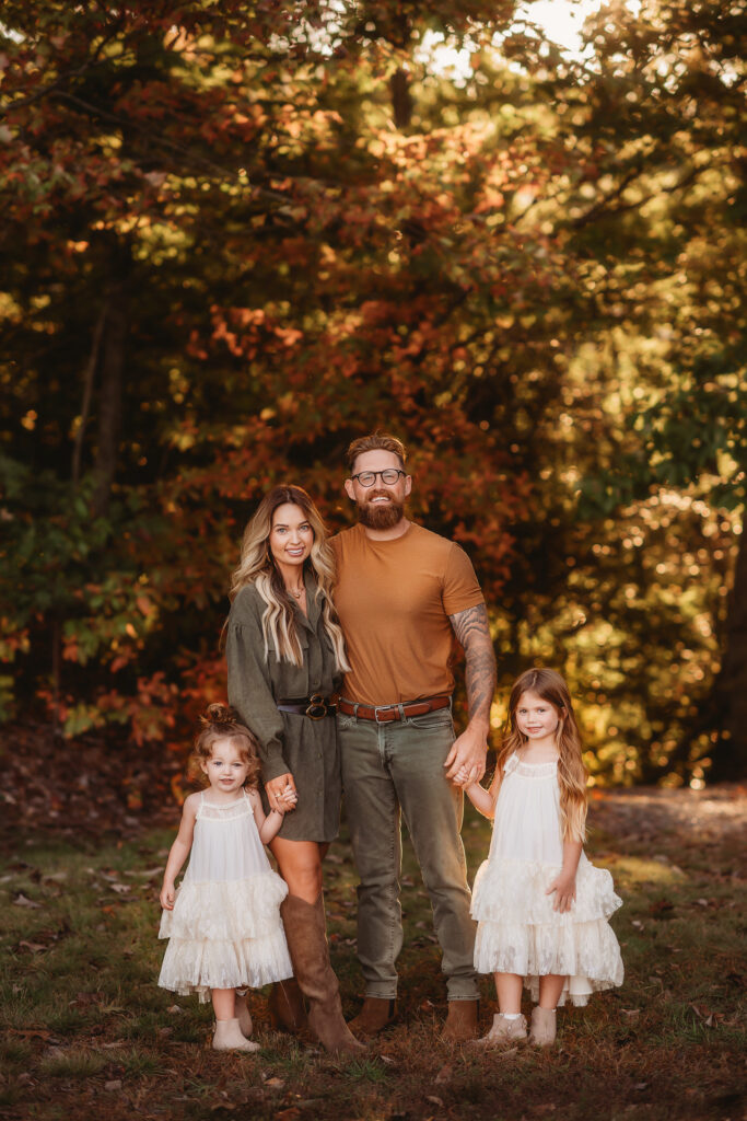 Family poses together for Fall, Family Portraits during Asheville Portrait Company's Fall Mini Sessions in Asheville along the Blue Ridge Parkway.