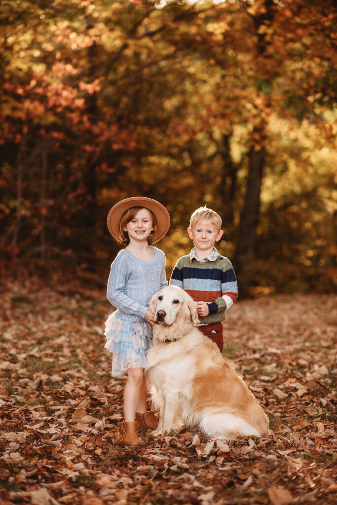 Siblings embrace and smile toward the camera during Fall Family Photos on the Blue Ridge Parkway in Asheville, NC.