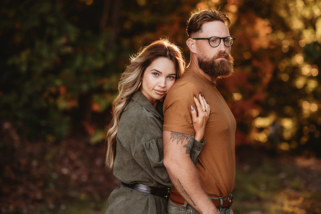 Wife embraces her husband during Fall Mini Sessions in Asheville, NC.