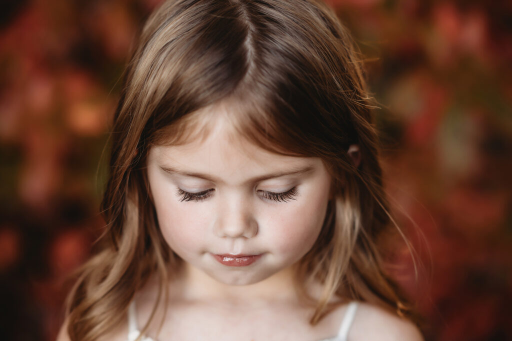 Little girl poses for a fine art portrait during Fall Mini Sessions in Asheville, NC.