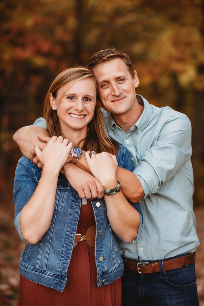 Couple embraces during Fall Family Photos on the Blue Ridge Parkway in Asheville, NC.
