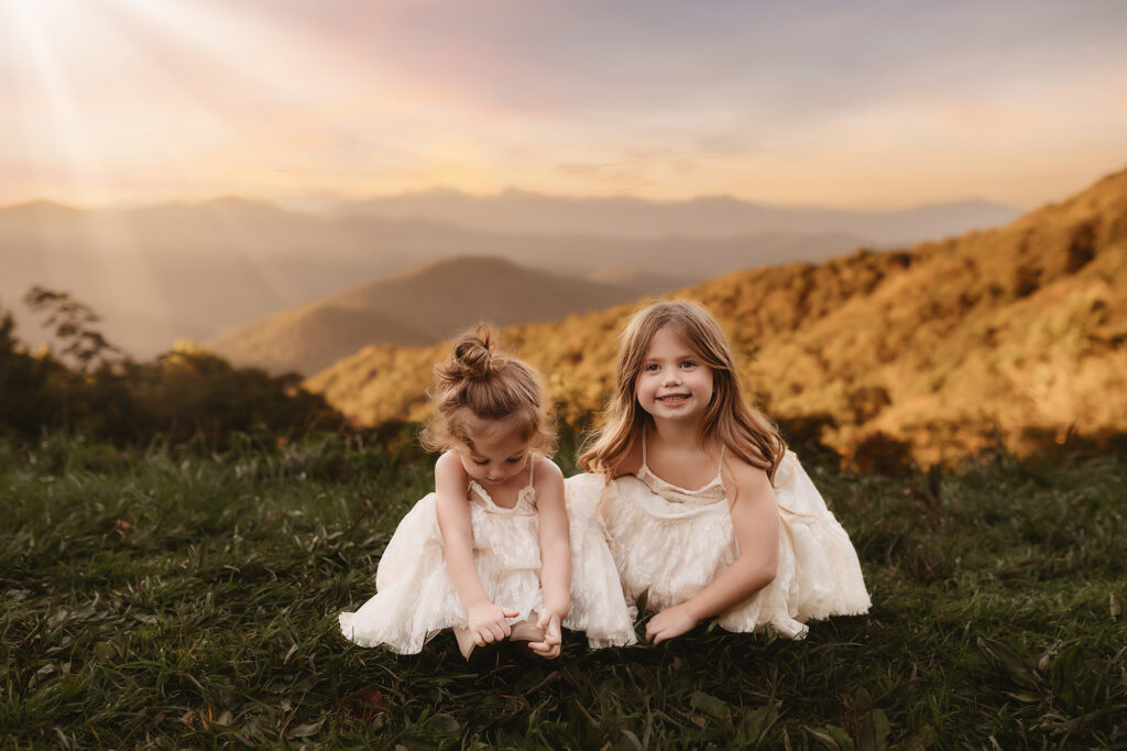 Siblings sit together on a mountain top during Fall Mini Sessions in Asheville, NC.