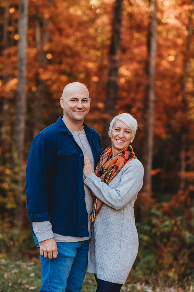 Couple poses for Fall Family Portraits in Asheville, NC after learning about the Best Places to See Fall Color in Asheville..