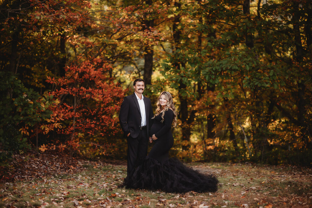 Expectant parents pose for Maternity Portraits in the fall, on the Blue Ridge Parkway with Asheville Portrait Company after Planning a Babymoon in Asheville, NC.