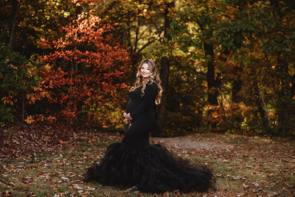 Expectant mother poses for Maternity Portraits in the fall, on the Blue Ridge Parkway with Asheville Portrait Company after Planning a Babymoon in Asheville, NC.