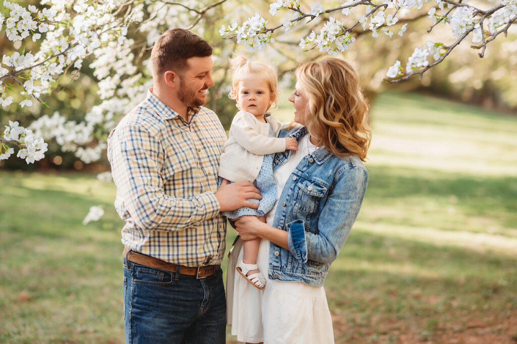 Parents embrace their baby during a Spring Photoshoot in Ashville, NC.