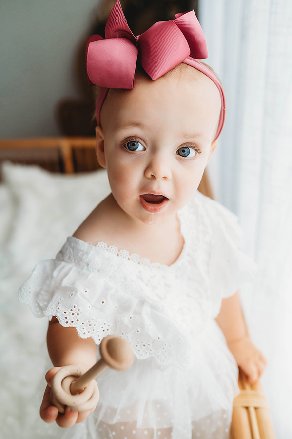 Child poses for All White Portrait Session at Asheville, NC Family Photography Studio.