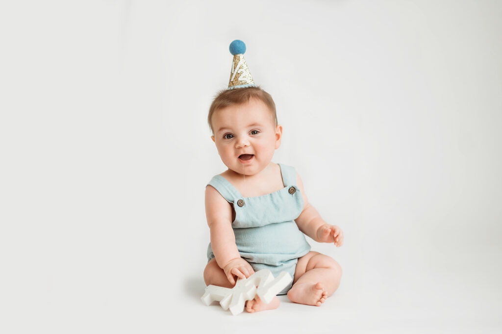 Baby poses for Birthday Cake Smash Portrait Session in Asheville, NC Photo Studio.