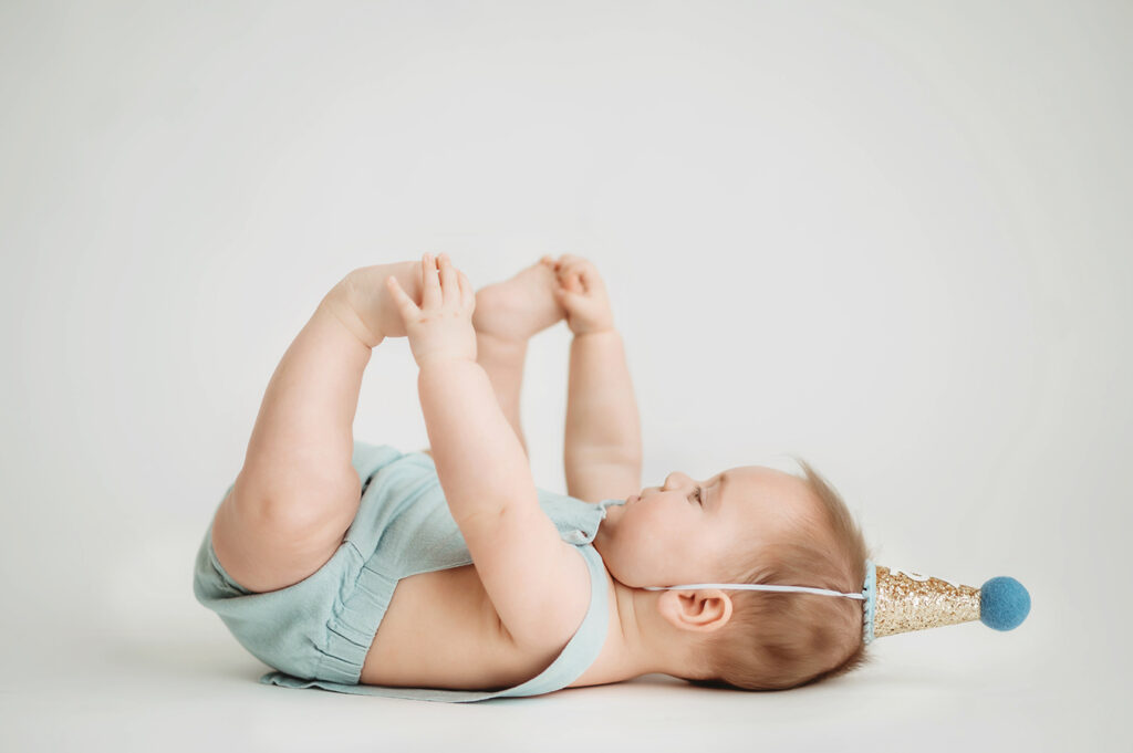 Baby poses for Birthday Cake Smash Portrait Session in Asheville, NC Photo Studio.