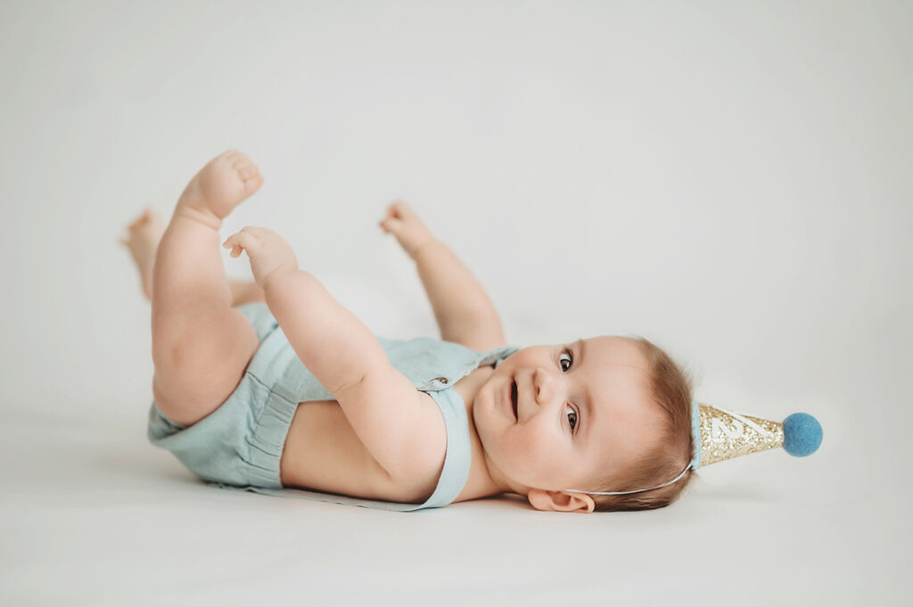Baby poses for Birthday Cake Smash Portrait Session in Asheville, NC Photo Studio.