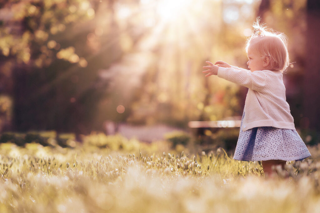 Baby plays in a field of flowers during a Spring Photoshoot in Asheville, NC.