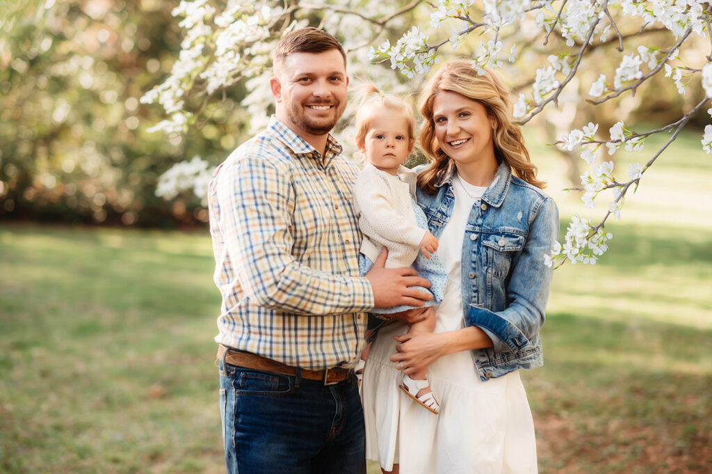 Parents embrace their baby during a Spring Photoshoot in Ashville, NC.