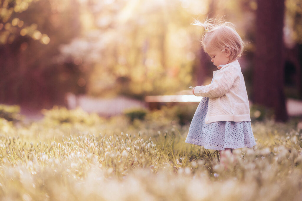Baby plays in a field of flowers during a Spring Photoshoot in Asheville, NC.