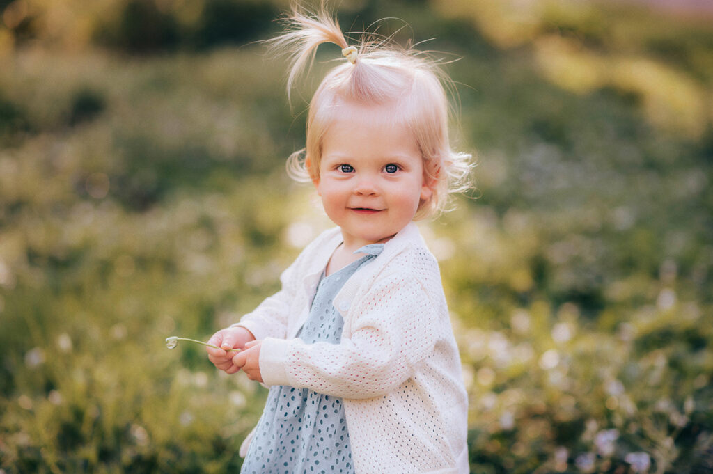 Baby plays in a field of flowers during a Spring Photoshoot in Asheville, NC.