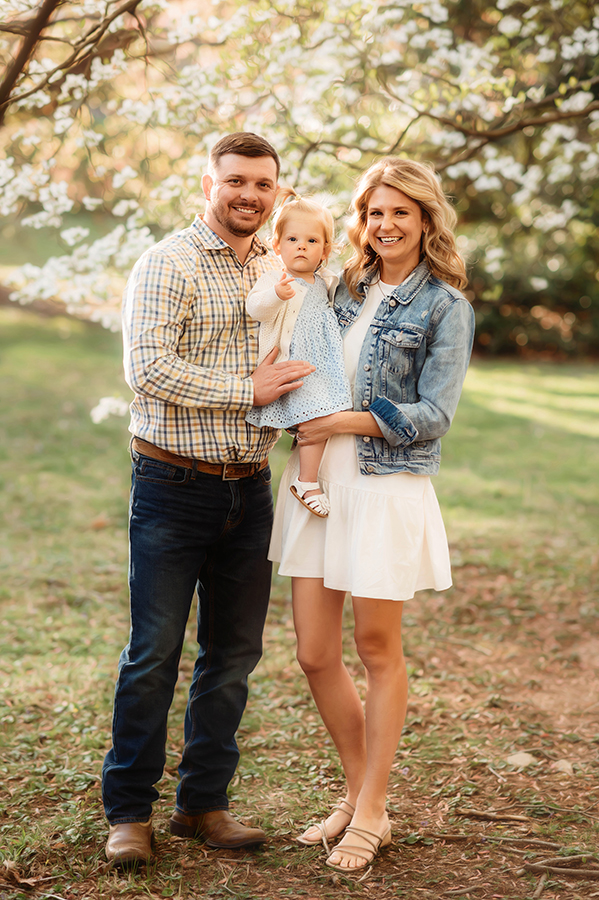 Parents embrace their baby during a Spring Photoshoot in Ashville, NC.