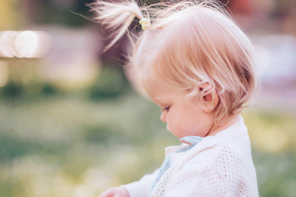Baby plays in a field of flowers during a Spring Photoshoot in Asheville, NC.