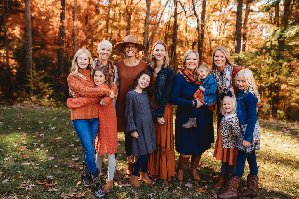 Extended Family poses together for Fall Family Portraits at Biltmore Estate in Asheville, NC after learning about the Best Places to See Fall Color in Asheville.