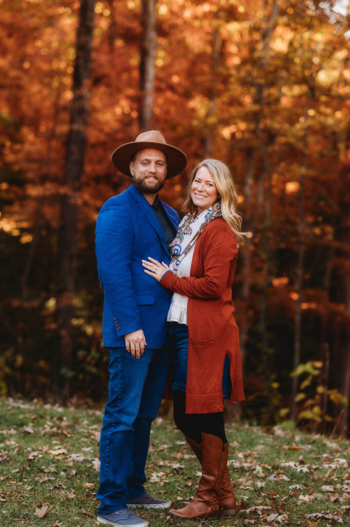 Couple poses for Fall Family Portraits in Asheville, NC after learning about the Best Places to See Fall Color in Asheville.