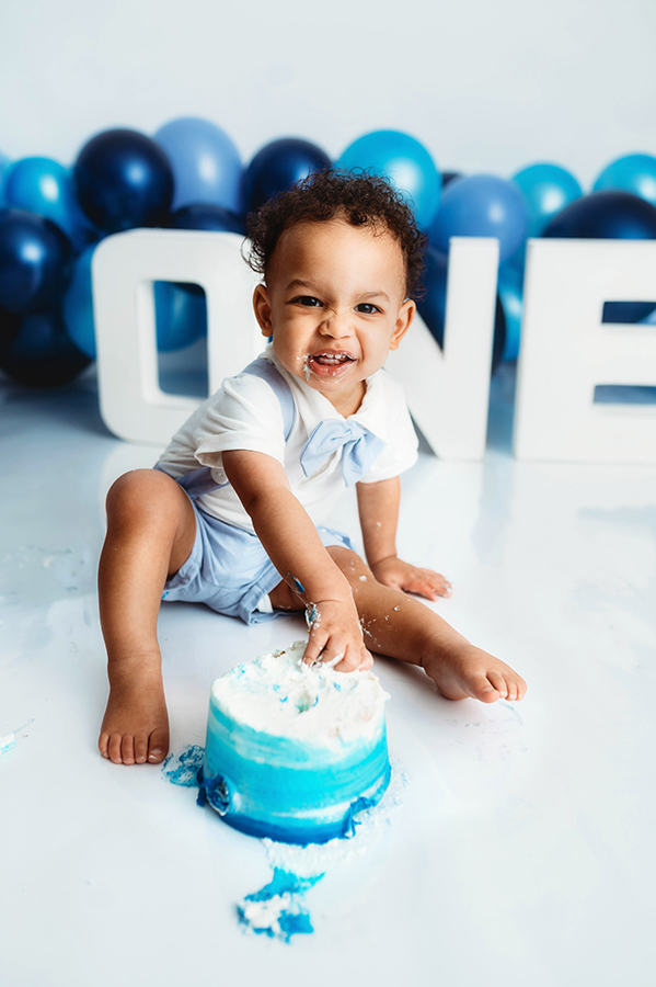 Baby poses for Birthday Cake Smash Photos at Asheville, NC Photography Studio.