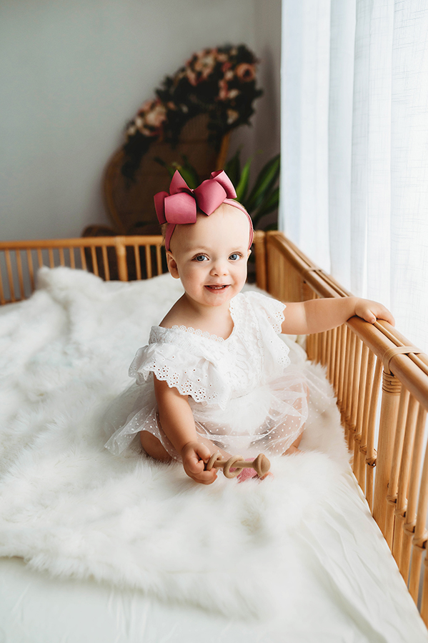 Candid Photos of a toddler during a simple, all white studio photoshoot in Asheville, NC portrait studio.