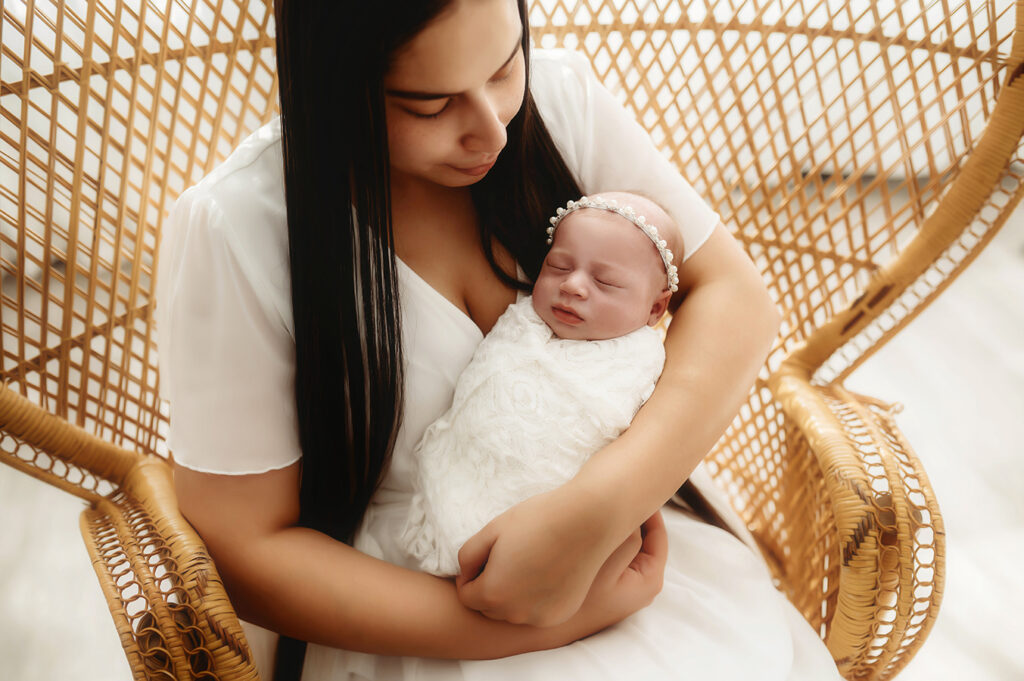 Mother poses with her Newborn Baby for Newborn Portrait Session in Asheville NC Newborn Photography Studio.