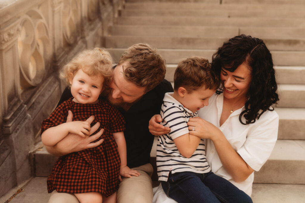 Parents embrace their children during Fall Family Photoshoot at Biltmore Estate in Asheville, NC.