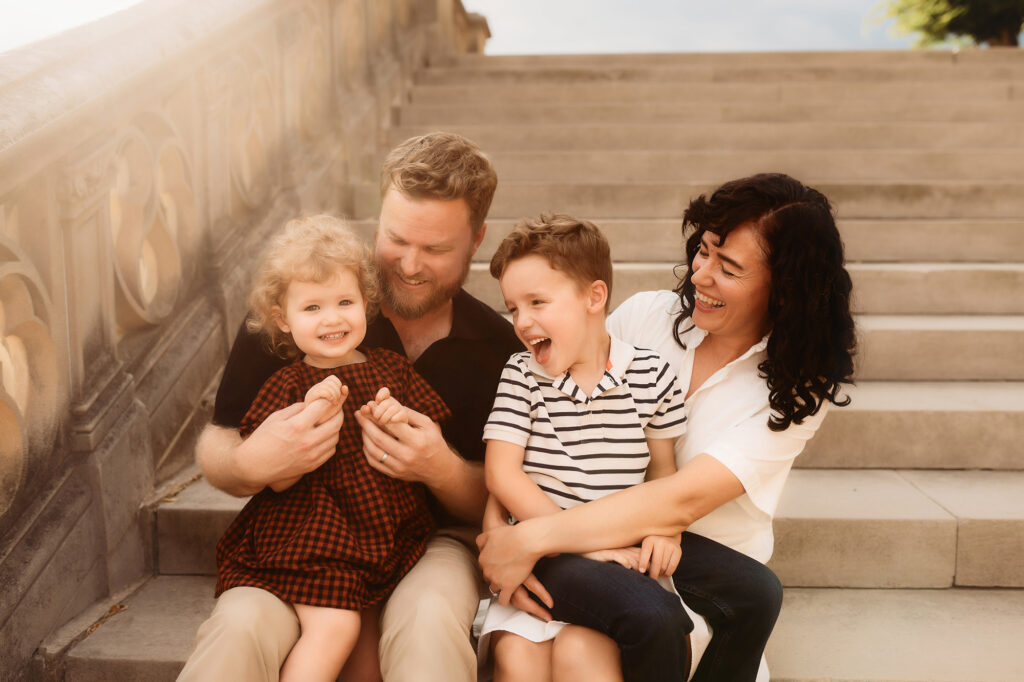 Parents embrace their children during Family Photoshoot at Biltmore Estate in Asheville, NC.
