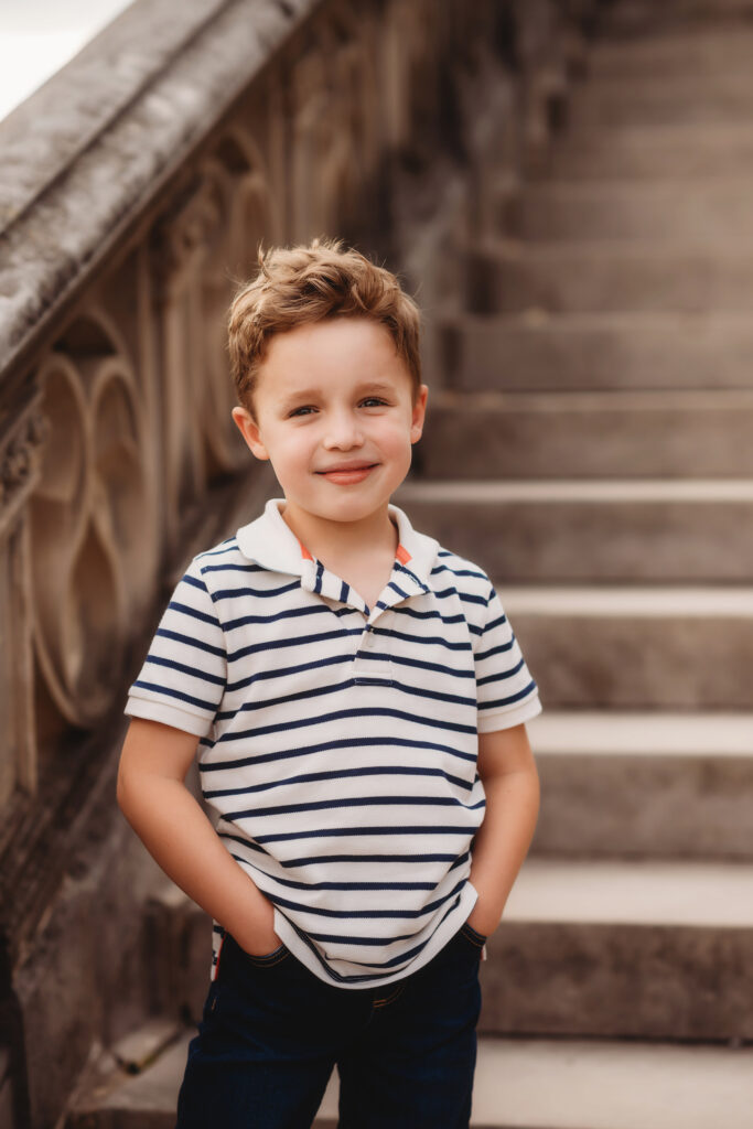 Little boy poses during Family Pictures at Biltmore Estate in Asheville, NC.