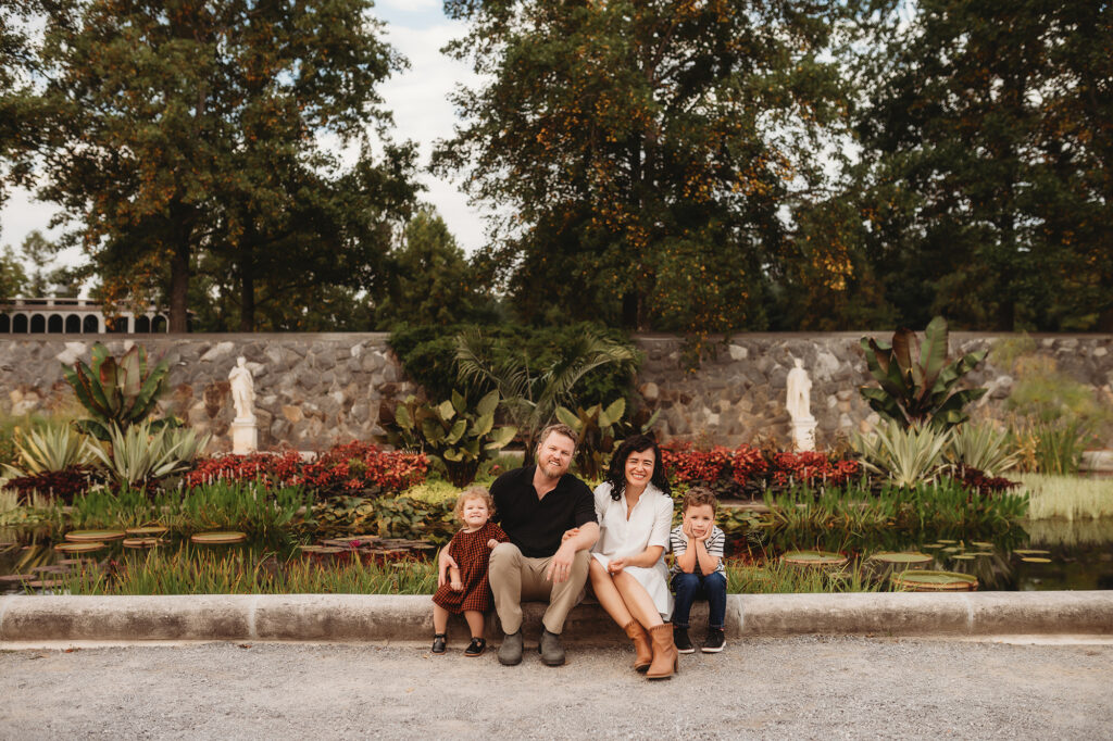 Family poses for Family Portraits in the Italian Garden at Biltmore Estate in Asheville, NC.