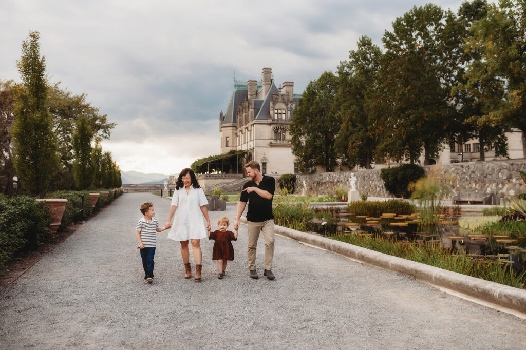 Family walks along the Italian Gardens at Biltmore Estate during their Fall Family Photoshoot in Asheville, NC.