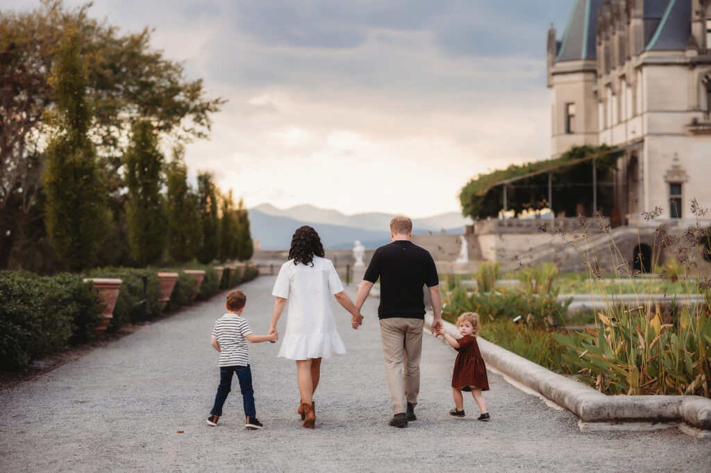 Family walks together during Fall Family Photos at Biltmore Estate in Asheville, NC.