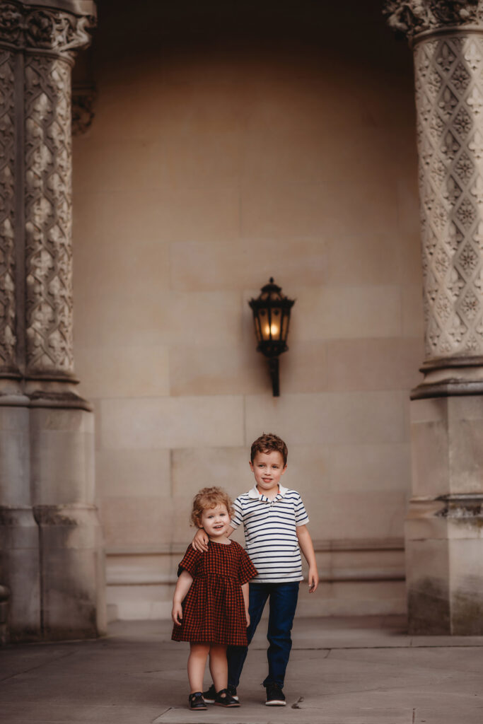 Siblings embrace during Fall Family Pictures at Biltmore Estate in Asheville, NC. eville, NC.