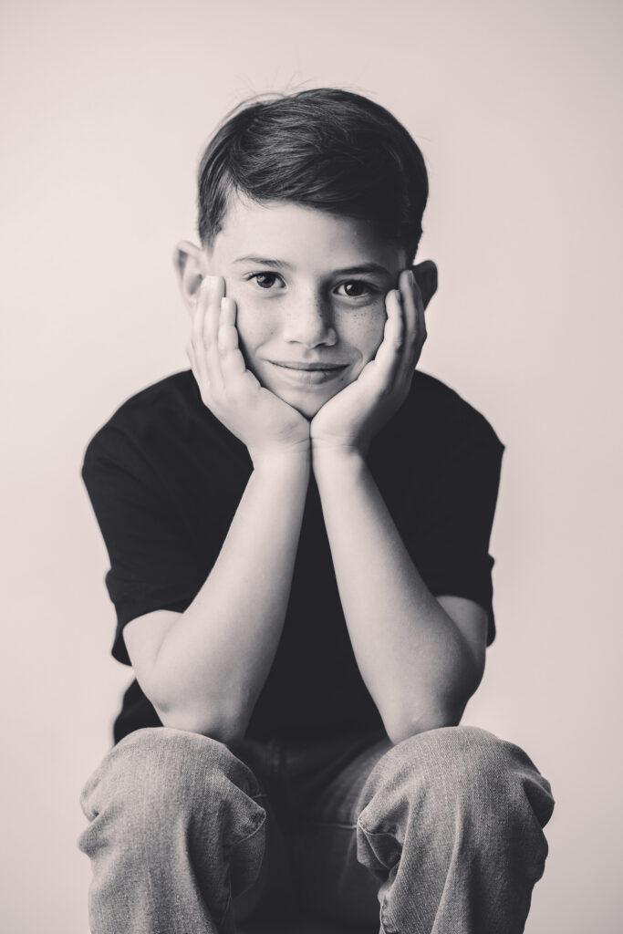 Young boy makes smiles at the camera during Asheville Personality Portrait Pop-Up.