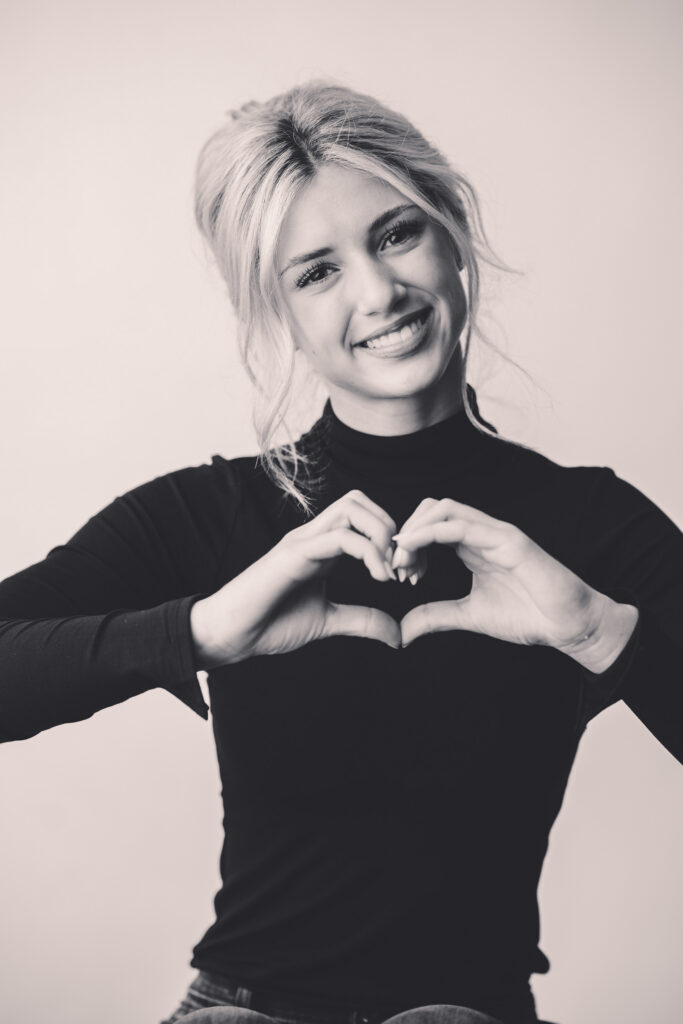 Young girl smiles at the camera during Asheville Personality Portrait Pop-Up.