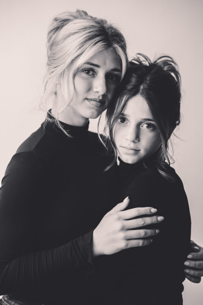 Sisters embrace during Personality Portrait Session in Asheville, NC.