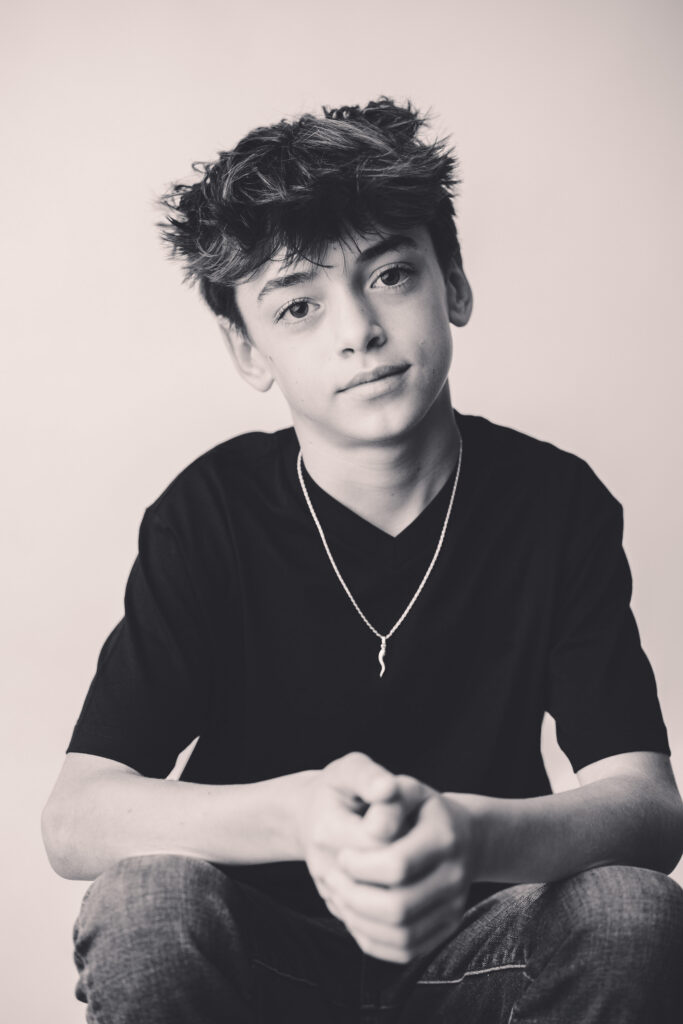 Young boy makes silly faces at the camera during Asheville Personality Portrait Pop-Up.