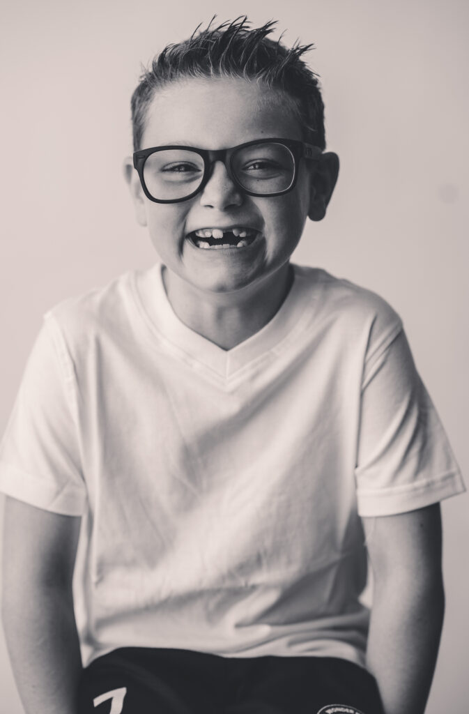 Young boy makes smiles at the camera during Asheville Personality Portrait Pop-Up.