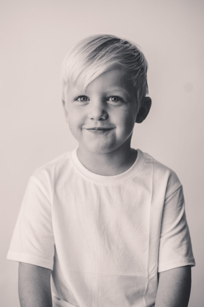Young boy makes smiles at the camera during Asheville Personality Portrait Pop-Up.