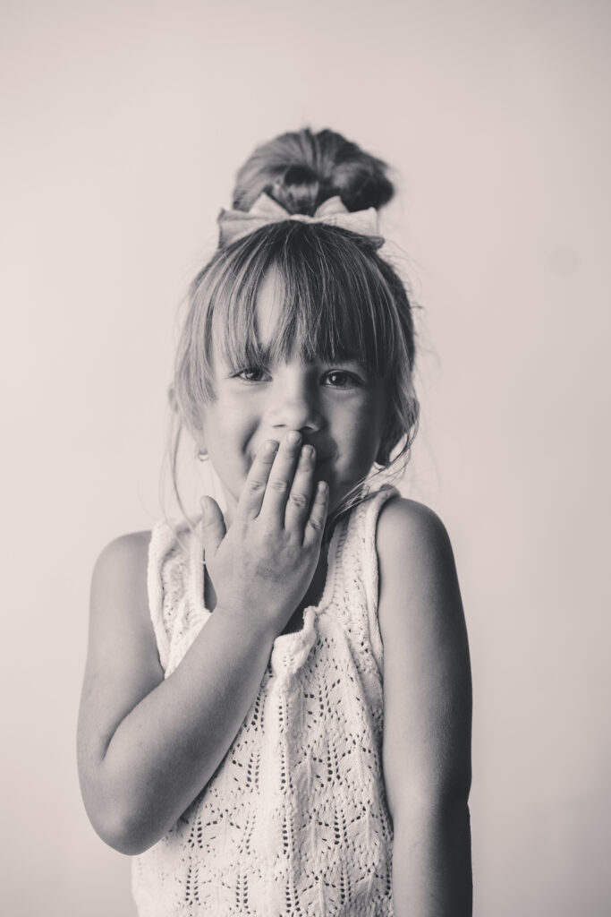 Child makes silly face at the camera during Personality Portrait Session in Asheville, NC.