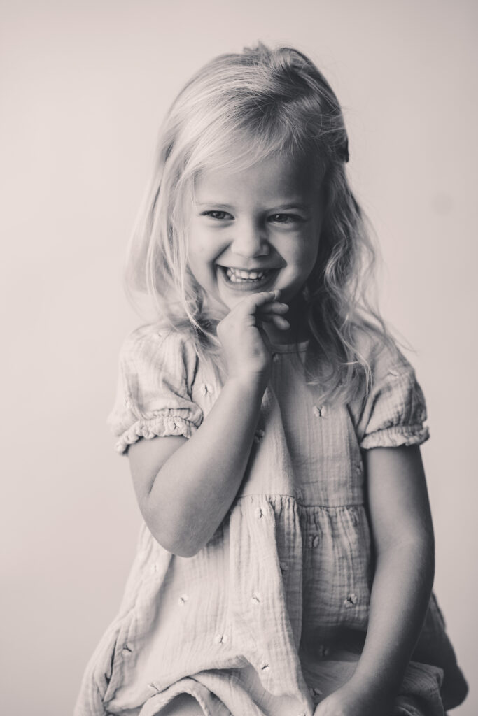 Little girl laughs off camera during the Asheville Personality Portrait Pop Up