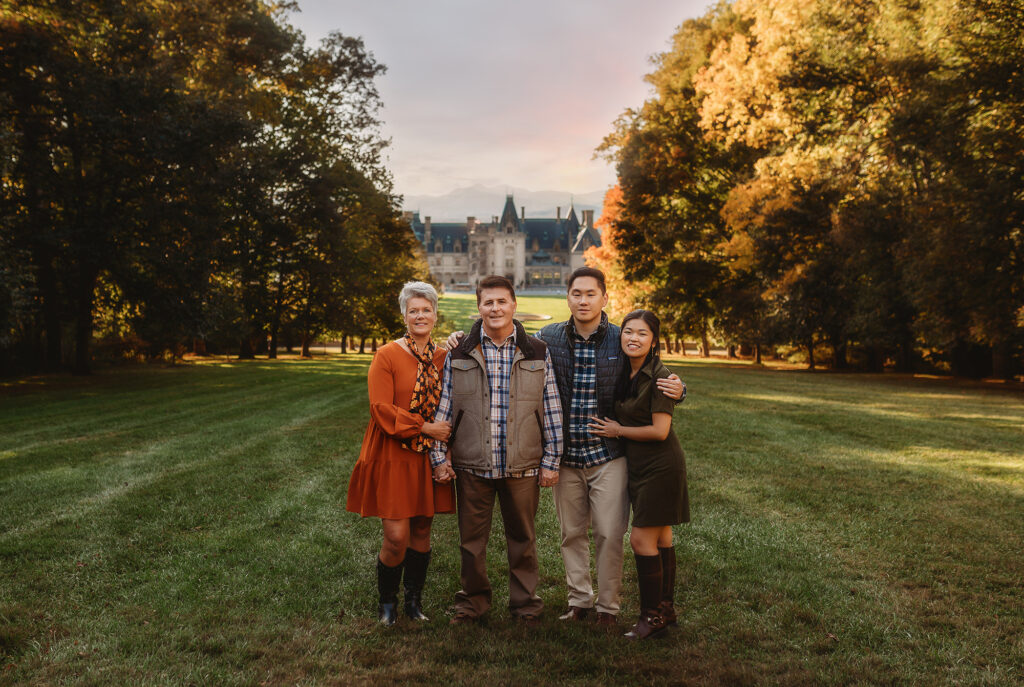 Family poses together on a hillside during their Biltmore Estate Family Photos.