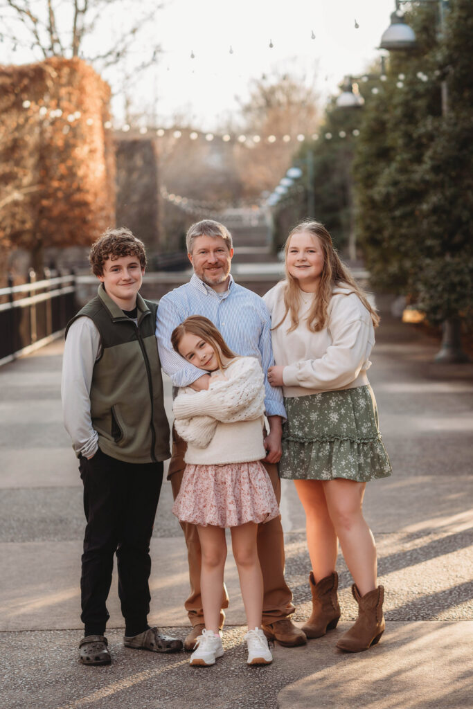 Father poses with his children during Multi-Generational Family Photoshoot at the NC Arboretum in Asheville, NC. 