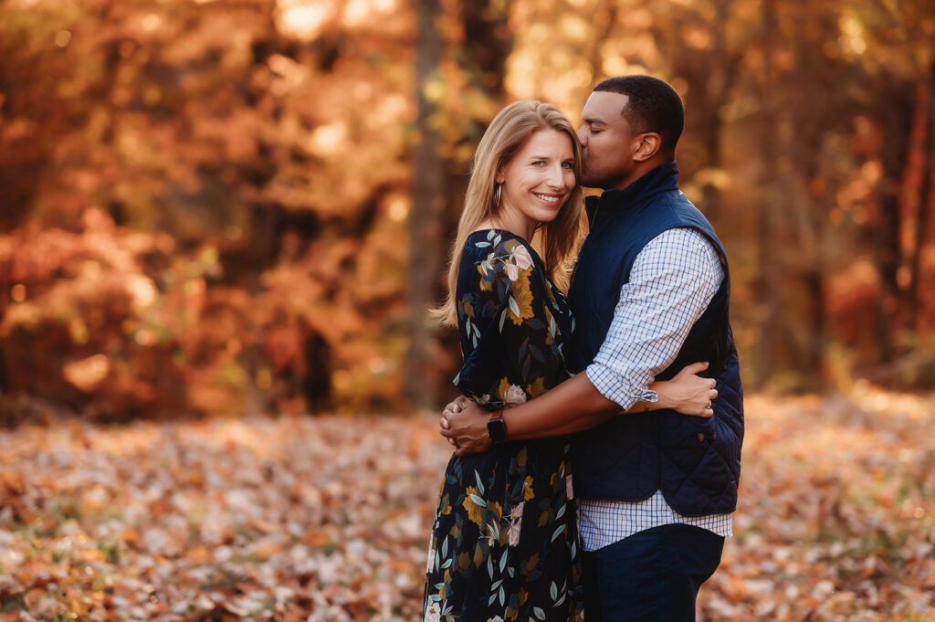 Couple embraces during Fall Family Portraits on the Blue Ridge Parkway in Asheville, NC.