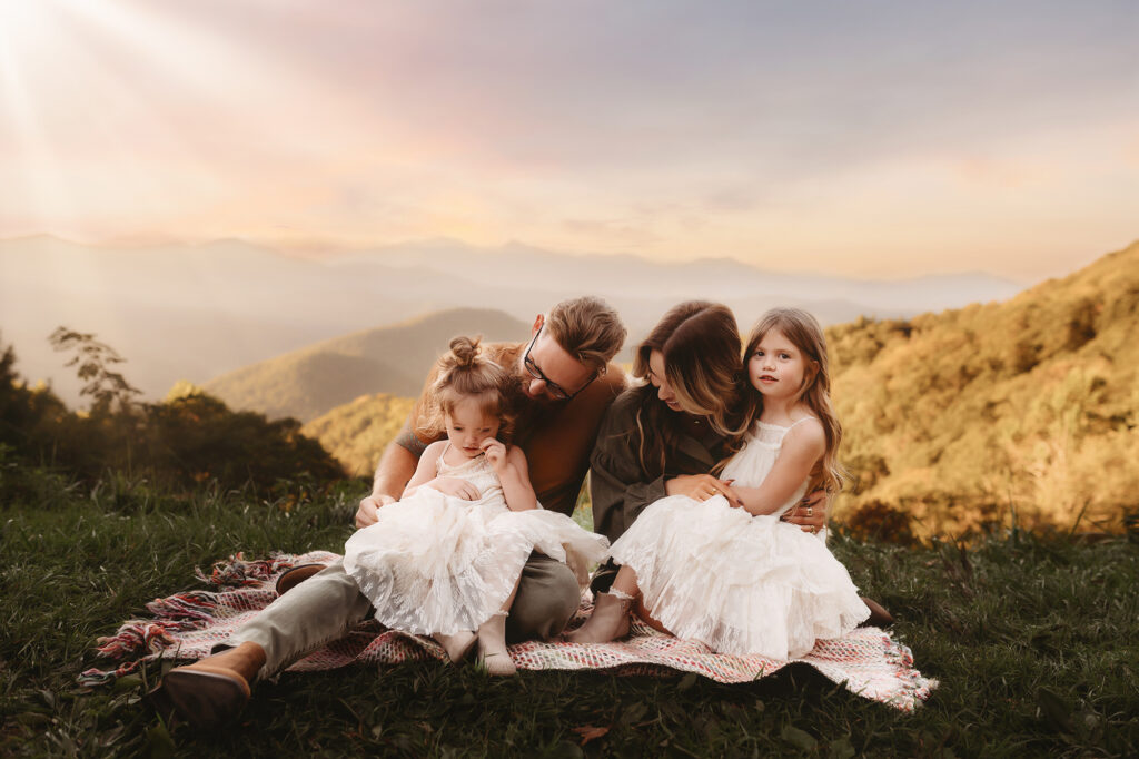 Family poses for Fall Family Photos on the Blue Ridge Parkway in Asheville, North Carolina.