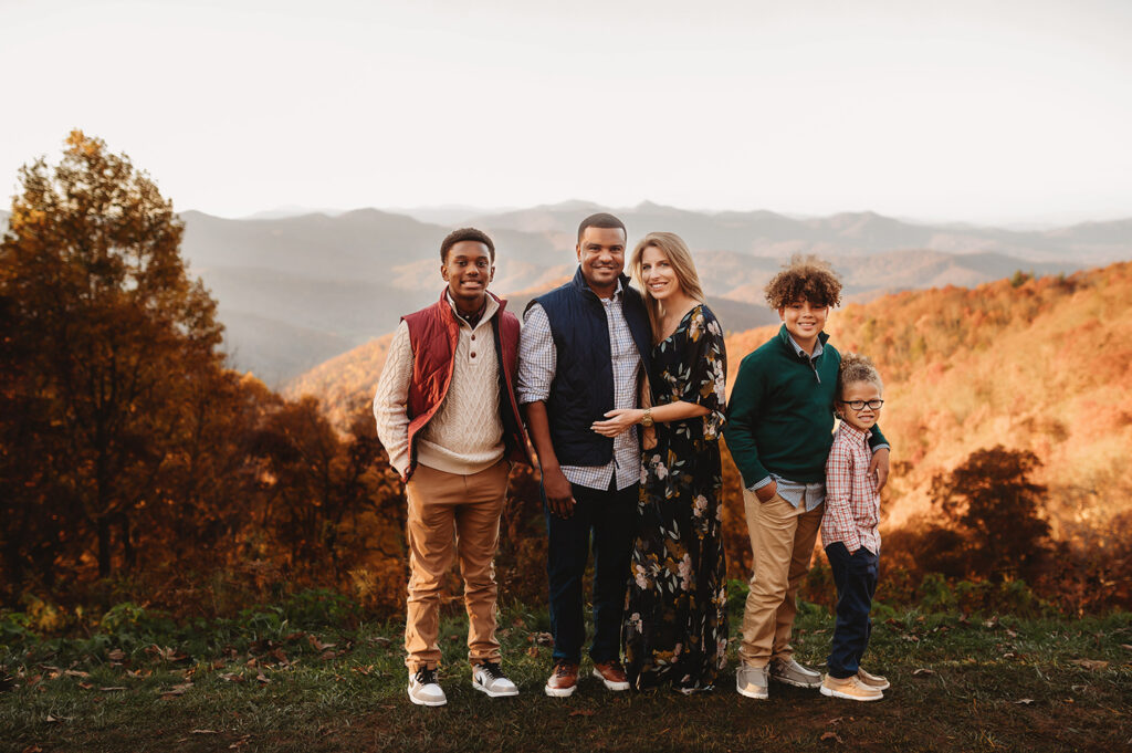 Family poses for Fall Family Portraits on a Mountain top during Family Portraits on the Blue Ridge Parkway in Asheville, NC.