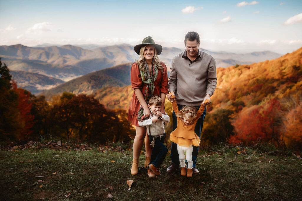 Family poses for Family Portraits on the Blue Ridge Parkway in Asheville, NC. Once of the best Fall Activities for Families in Asheville. 