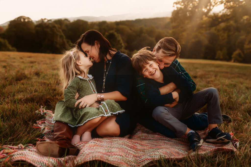 Parents embrace their children during Family Photoshoot at Biltmore Estate in Asheville, NC.
