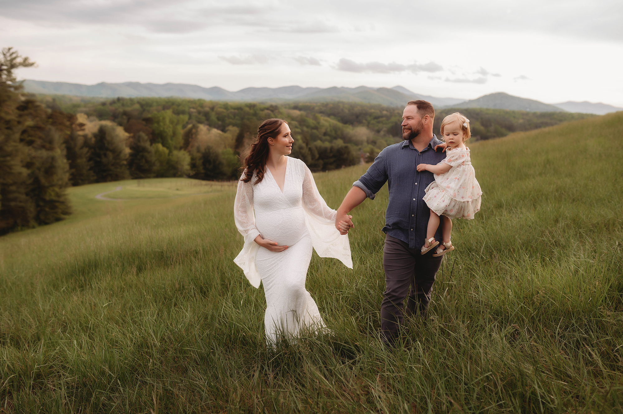 Expectant parents walk together during Maternity Portrait Session at Biltmore Estate in Asheville, NC.